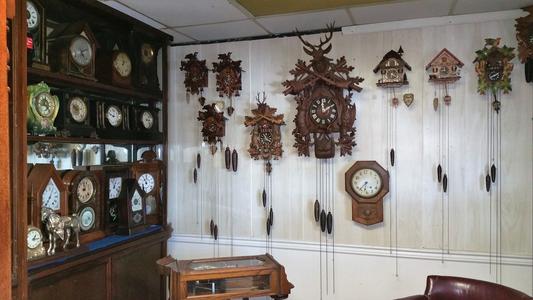 Wall display of antique cuckoo clocks and timepieces